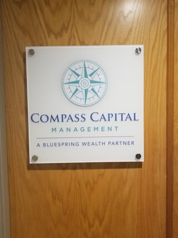 Compass Capital Management panel sign on door