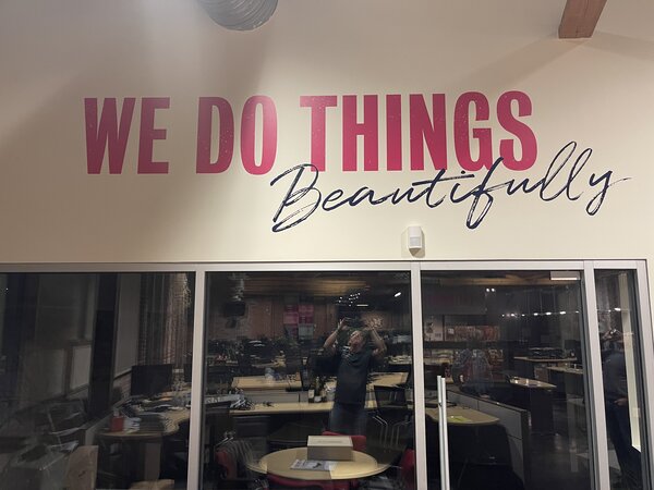 Wall lettering showing Do the things beautifully